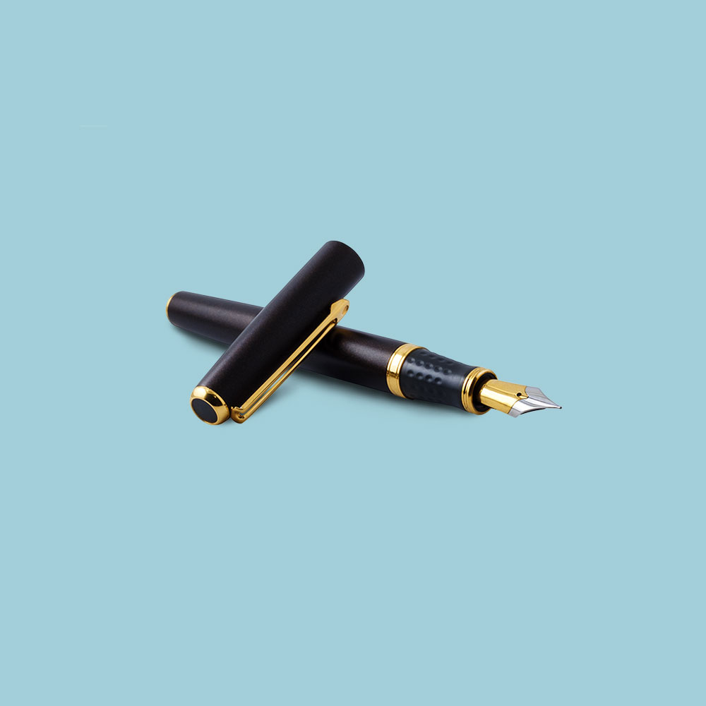 Black fountain pen with gold decorative detailing on pale blue background
